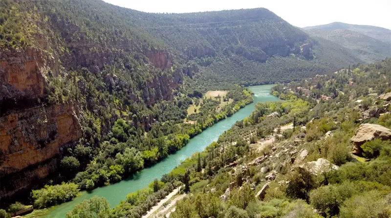 . Raid mtb high atlas riders biking through Aït Bouguemaz Valley’s terraced fields