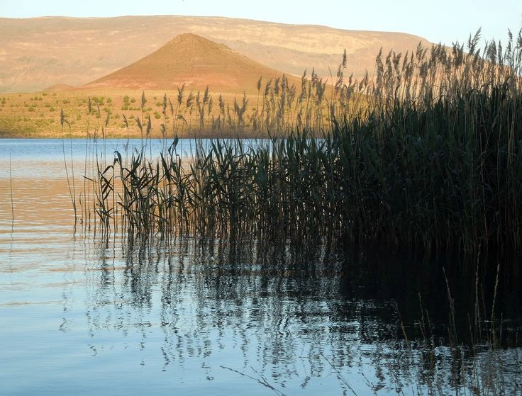 Serene waters of Lake Tislit surrounded by high peaks