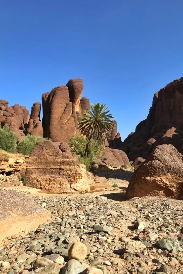 Scenic view of Lake Tislit Valley surrounded by mountains